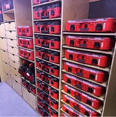 the shelves are full of red tool boxes