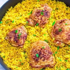 chicken and rice in a skillet with parsley on the side, ready to be eaten