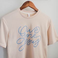 Infuse your faith into your everyday style with our Give Me Jesus Tee. Made from an extremely soft polyester-spandex blend, this cream shirt features a beautiful script design by the Daily Grace Co. team. Inspired by a beloved hymn, it's a great reminder to keep your focus on Jesus. Want to know if this will fit? Check our sizing chart! Bible Verse Shirt Design, Trendy Tshirt Designs, Jesus Shirts Women, Jesus Merch, Church Merch, Daily Grace Co, Women Tshirt Design, Christian Clothes, Christian Graphics