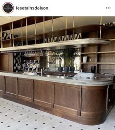 an empty bar in the middle of a room with black and white tile flooring