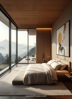 a large bed sitting in the middle of a bedroom next to a tall glass wall