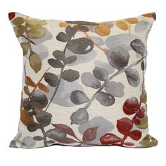 a decorative pillow with leaves and berries on it