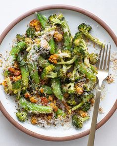 a white plate topped with broccoli covered in parmesan cheese