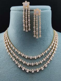 Experience the fusion of American innovation and Indian artisanship in our latest creation. Designed in the USA and meticulously handcrafted in India, this necklace set boasts american diamonds. Its design ensures effortless pairing with any ensemble, adding a touch of versatility to your jewelry collection. A symbol of boundless creativity and cross-cultural love, it's more than just a necklace – it's a statement of modern elegance. Handcrafted Metal: Metal Alloy, Gold Plated Necklace Set inclu Diamond Necklace Set Indian, Modern Indian Jewelry, Diamond Jewellery Set, American Diamond Necklace Set, Fancy Jewelry Necklace, Gold Jewellry, Diamond Jewelry Set, American Diamond Necklaces, Necklace Set Indian