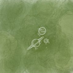 an image of the planets drawn in chalk on a green paper with white marker marks