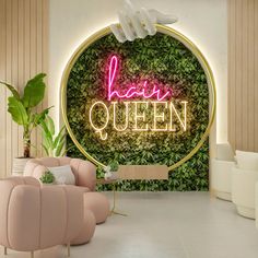 a living room filled with furniture and a neon sign on the wall that says happy queen