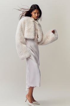 Introducing our new Alyana Faux Fur Jacket, the perfect topper for your favorite dress. This ultra-soft, plush coat adds a touch of glam to any outfit while keeping you warm and stylish. Its cropped length is designed to flatter, making it the ideal piece to throw on for a night out or a special occasion. Fabrication: Luxe Faux Fur; 100% Polyester Sonali is wearing a size S and is 5'10" with a 31" bust, 35" hips, and 23" waist Plush Coat, Faux Fur Jacket, Favorite Dress, Fur Jacket, Soft Plush, Faux Fur, Night Out, Special Occasion, Fabric