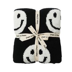 two towels wrapped in black and white with smiley faces on them