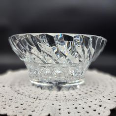 a glass bowl sitting on top of a white doily