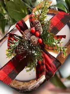 an ornament with pine cones and berries on it