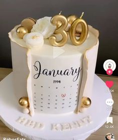 a white and gold birthday cake with the number twenty five on it's side