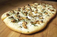 a pizza sitting on top of a wooden cutting board