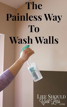 a person holding a plastic bottle with the words the painless way to wash walls