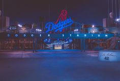 the dodgers stadium sign lit up at night