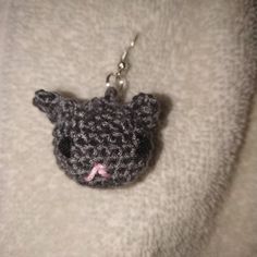 a crocheted cat keychain with a pink nose