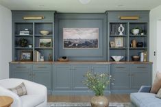 a living room filled with lots of furniture and bookshelves next to each other