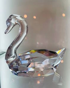 a crystal swan sitting on top of a table