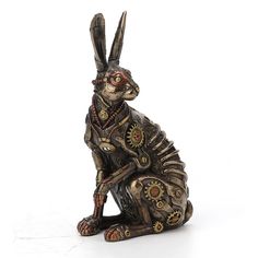 a statue of a rabbit with gears on its body and legs, sitting in front of a white background