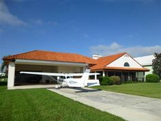 an airplane parked in front of a house