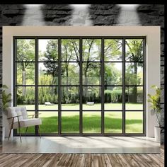 an open window in a room with wood flooring and stone walls, overlooking a grassy area