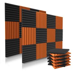 an orange and black paneled wall next to a stack of books on top of each other