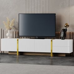 a flat screen tv sitting on top of a white entertainment center