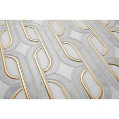 a white marble and gold metal wallpaper with an intricate design on the top part