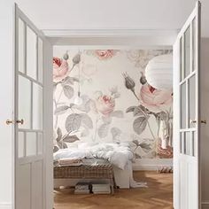 an open door leading to a bedroom with pink flowers on the wall and white walls