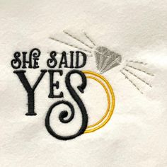 she said yes embroidered on a white shirt with black and yellow details, which reads she said yes