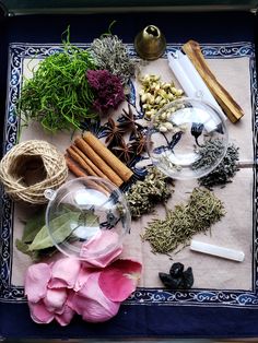 an assortment of herbs and spices on a blue tray next to twine of twine