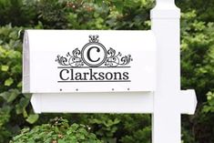 a white sign with the name clarksons on it in front of some trees