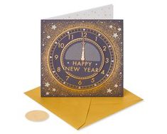 a happy new year card with an image of a clock and stars on the front