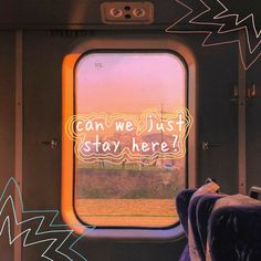 an airplane window with the words can we just stay here? written in neon lights