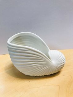 a white bowl sitting on top of a wooden table