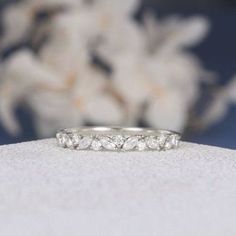 three stone diamond ring sitting on top of a table