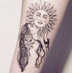 a woman's arm with a sun and feathers tattoo design on the left forearm