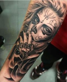 a woman's arm with a tattoo on it and a skull in the middle