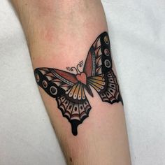 a small butterfly tattoo on the arm