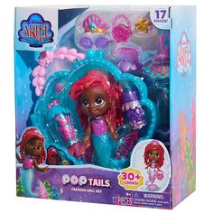 the little mermaid doll has pink hair and is in its box with accessories on it