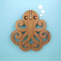 a wooden clock with an octopus on it's face and thought bubble above the clock