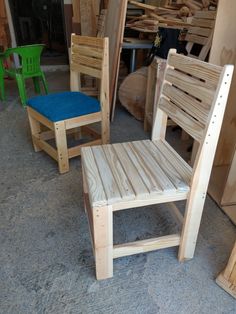 three wooden chairs sitting next to each other in a room filled with wood planks