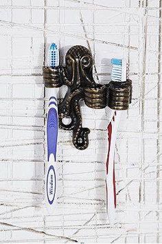 an octopus toothbrush holder is hanging on the wall