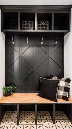 a black and white mud room with a bench