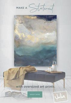 a large painting hanging on the wall next to a couch and coffee table in front of it