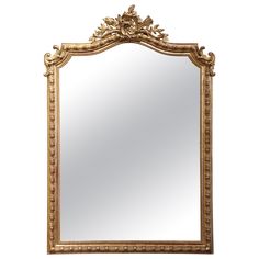 an ornate gold framed mirror against a white wall