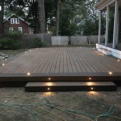 a wooden deck with lights around it