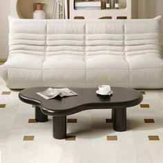 a living room with a white couch and coffee table