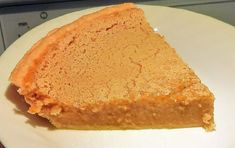 a piece of pie sitting on top of a white plate next to a computer keyboard