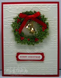 a christmas card with a wreath and bells