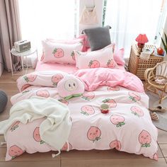 a pink bed with strawberrys on it